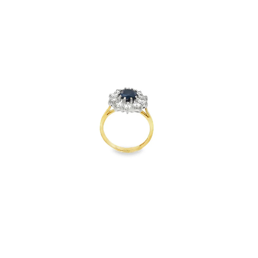 Sapphire and diamond cluster ring in 18ct yellow gold with oval sapphire and round brilliant cut diamonds.