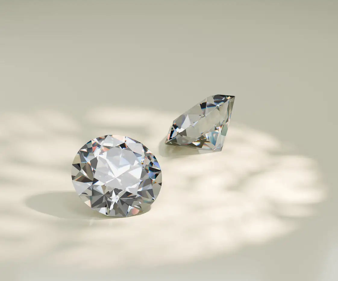 Two diamonds, one round and one pear-shaped, on a light background