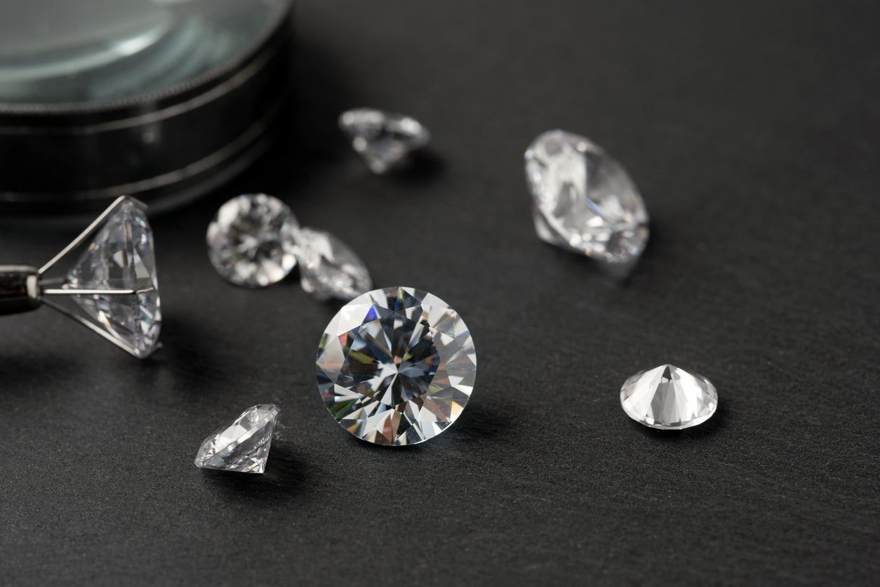 Loose lab-grown diamonds displayed on jeweller’s desk
