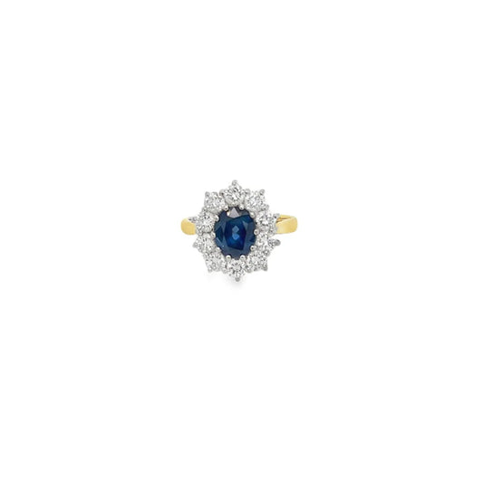 Sapphire and diamond cluster ring in 18ct yellow gold, featuring an oval sapphire and round brilliant cut diamonds.